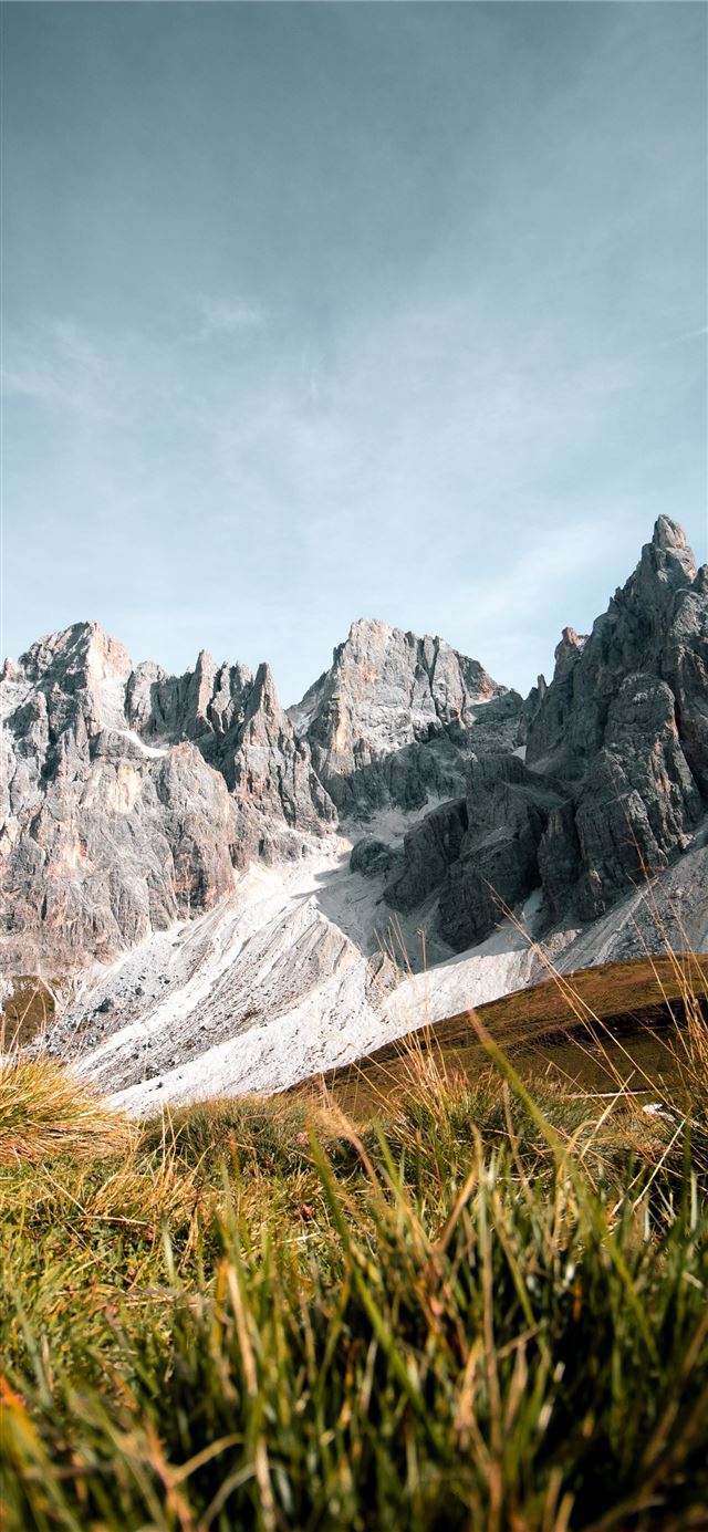 1125x2436 grass field near rock formation - dolomites iPhone 11 Wallpaper