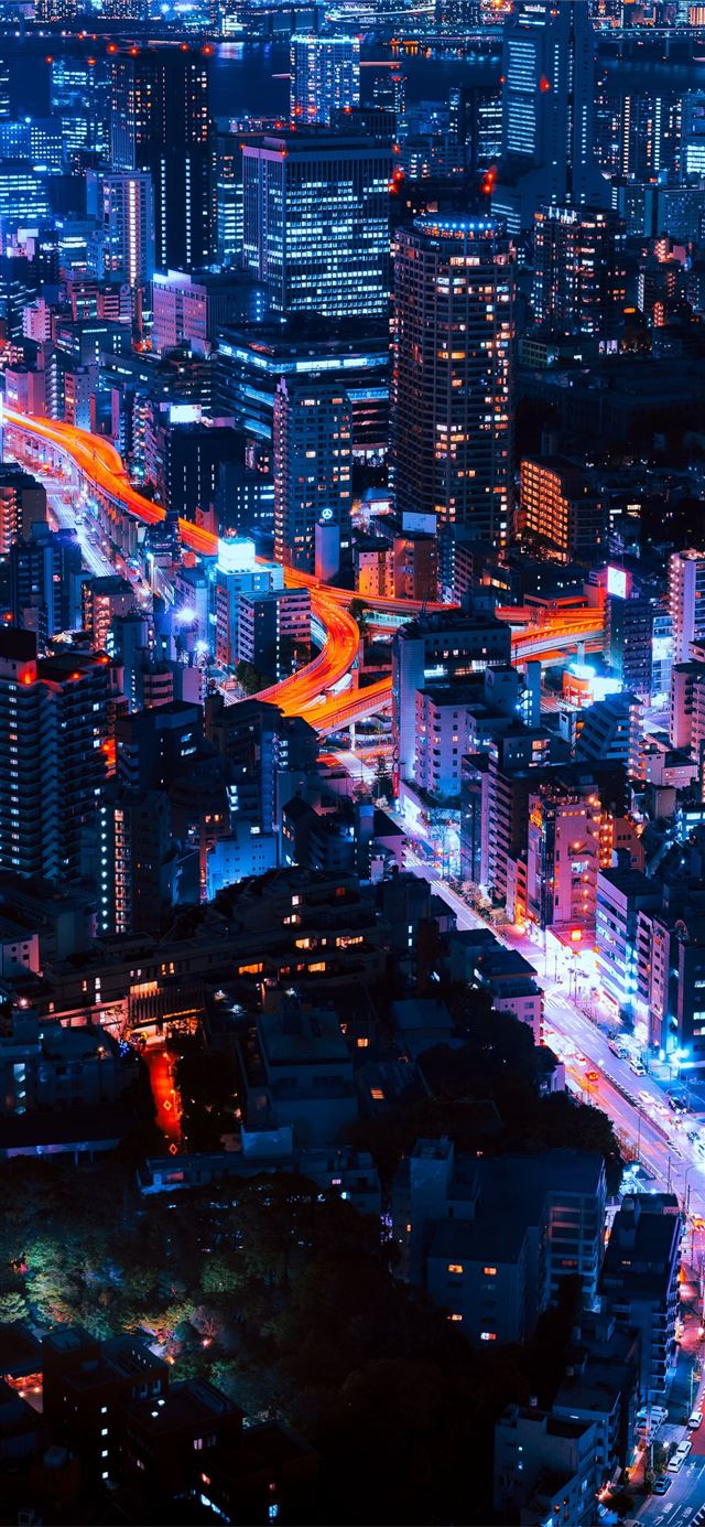 1125x2436 timelapse photography of vehicles and buildings - tokyo iPhone 11 Wallpaper