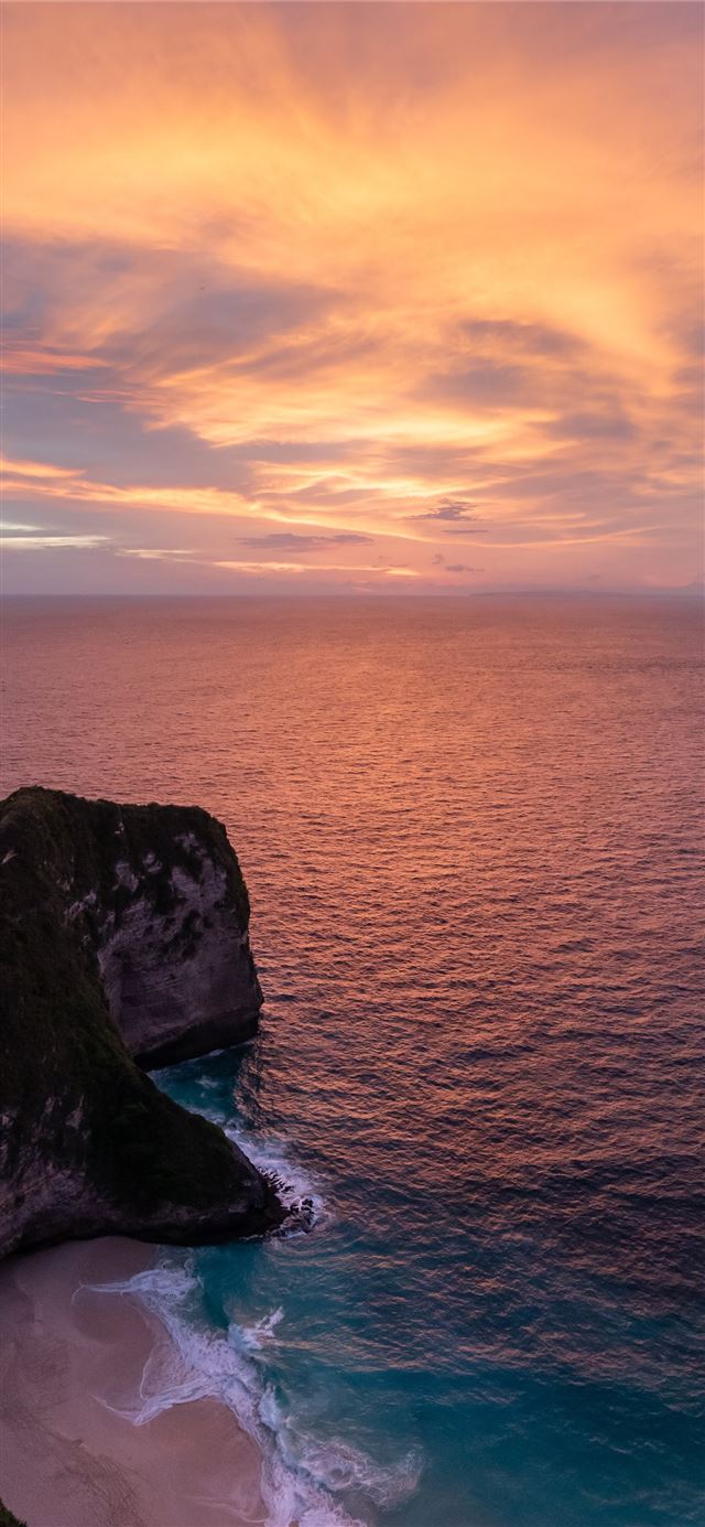 1125x2436 dinosaur shaped island beside sea - sunset iPhone 11 Wallpaper