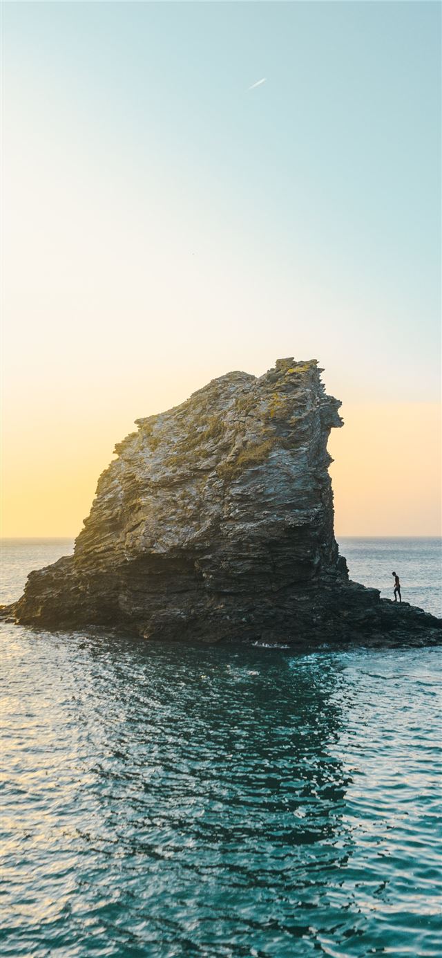 1125x2436 two people standing on rock formation surrounded b... - ocean iPhone 11 Wallpaper