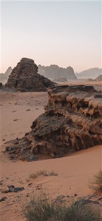 brown rock formation on brown field wallpaper