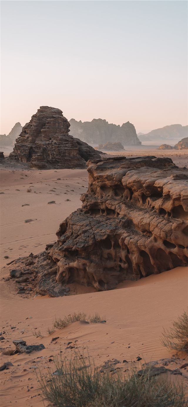 1125x2436 brown rock formation on brown field - outer space iPhone 11 Wallpaper
