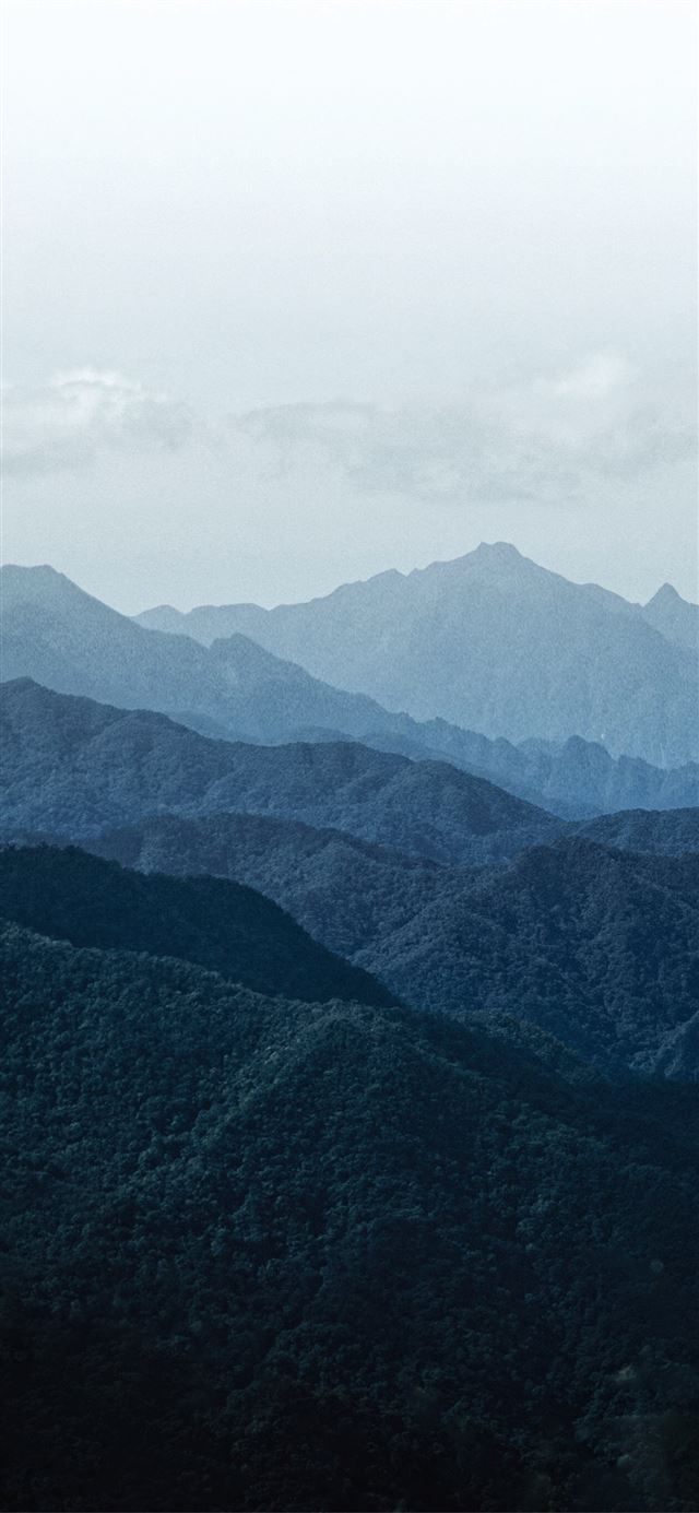 1125x2436 green mountains under white sky during daytime - grey iPhone 11 Wallpaper