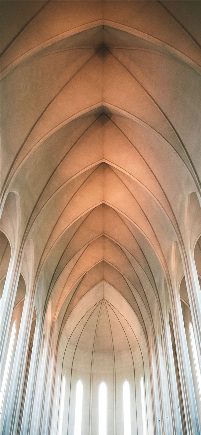 1125x2436 low angle photography of concrete building - iceland iPhone 11 Wallpaper