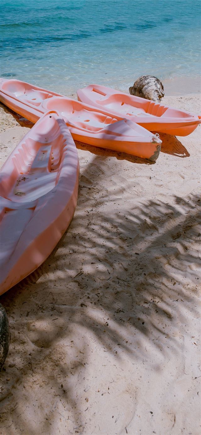 1125x2436 three empty kayaks - beach iPhone 11 Wallpaper