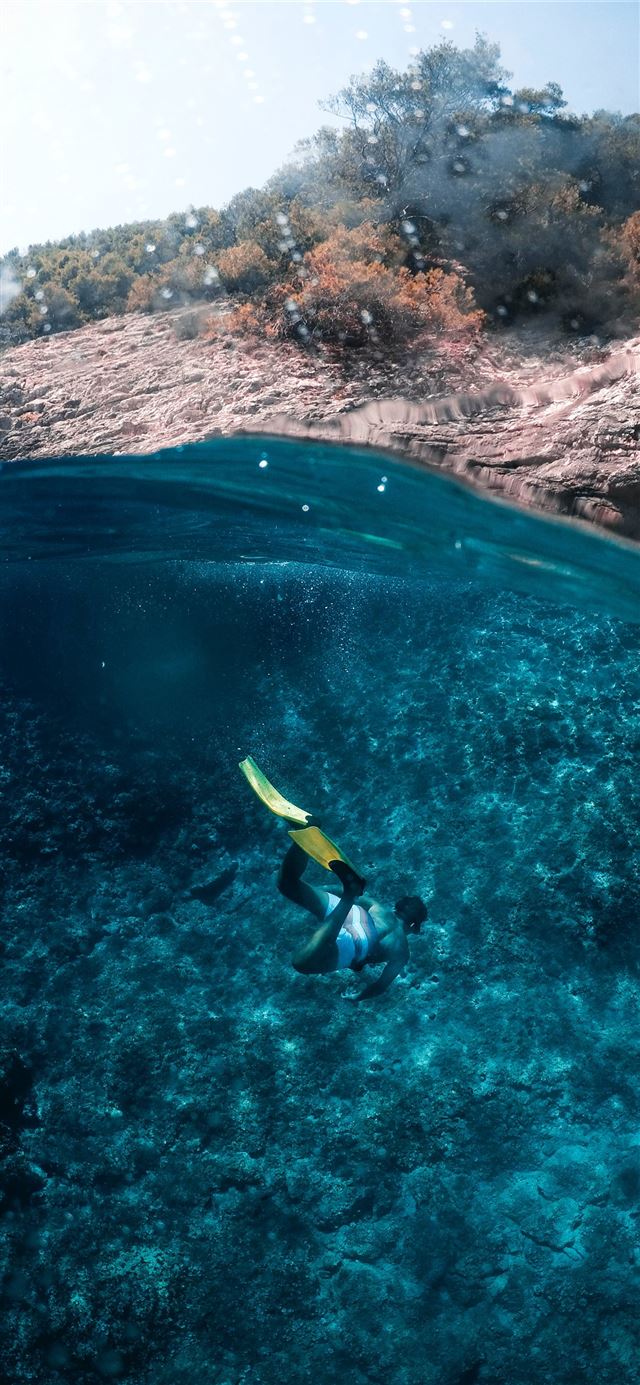 1125x2436 person diving on body of water - croatia iPhone 11 Wallpaper