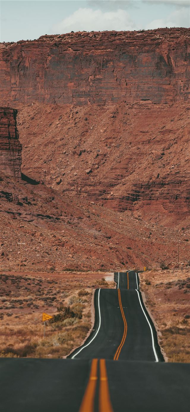 1125x2436 white car on road near brown rock formation during... - brown iPhone 11 Wallpaper