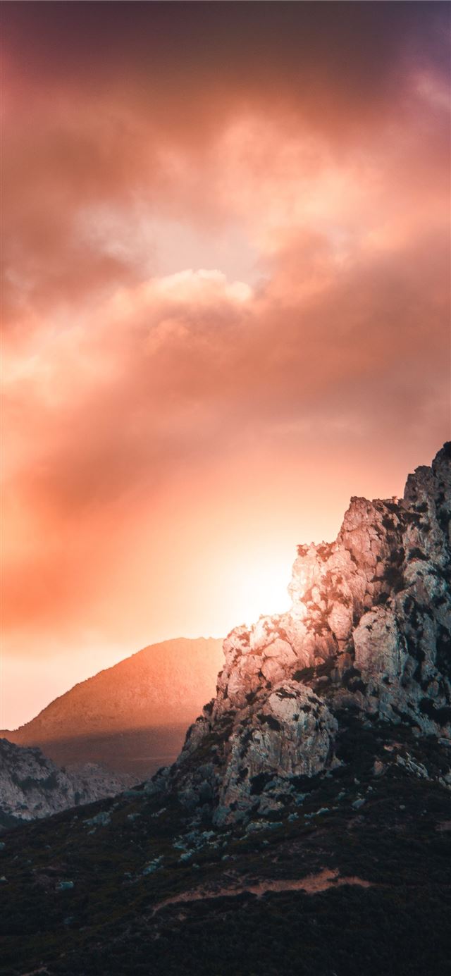 1125x2436 black and gray hill under cloudy sky during sunset - orange iPhone 11 Wallpaper