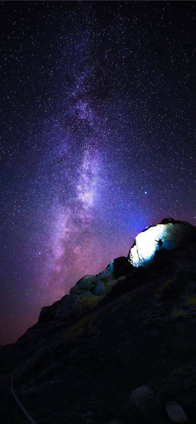 1125x2436 person standing on rock mountain under starry nigh... - outer space iPhone 11 Wallpaper