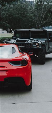 red Ferrari car and black Hummer SUV iPhone 11 wallpaper