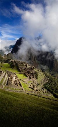 cloudy day overlooking the ruins of machu picchuru... wallpaper