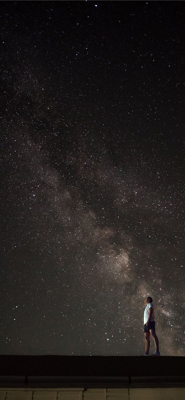 1125x2436 man looking up to Milky Way galaxy at night sky -  iPhone 11 Wallpaper