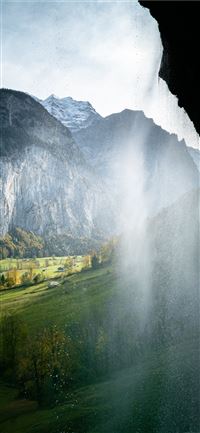 green grass field near mountain during daytime wallpaper