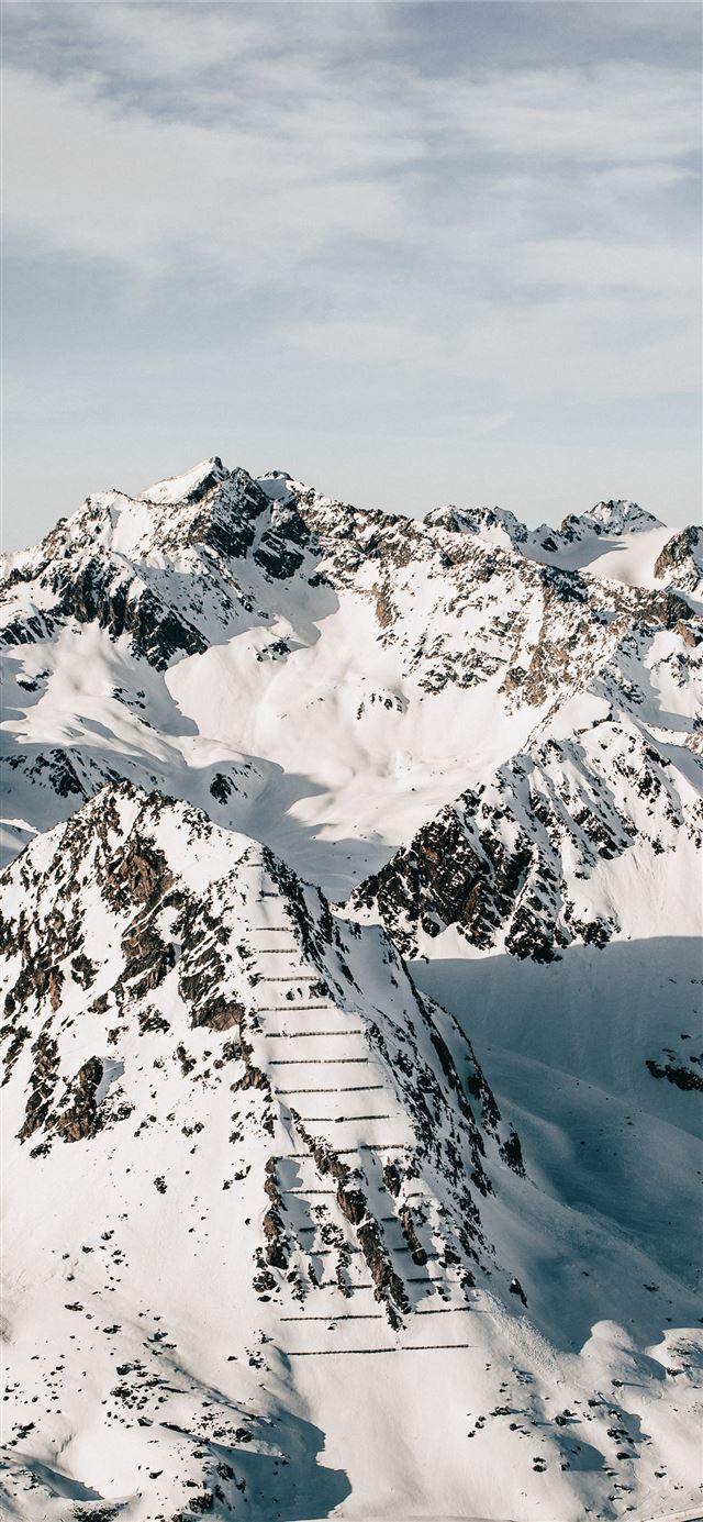 1125x2436 snow covered mountain under cloudy sky during dayt... - grey iPhone 11 Wallpaper