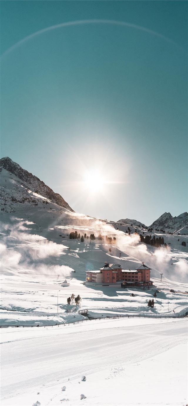 1125x2436 brown building on snow field during daytime - austria iPhone 11 Wallpaper