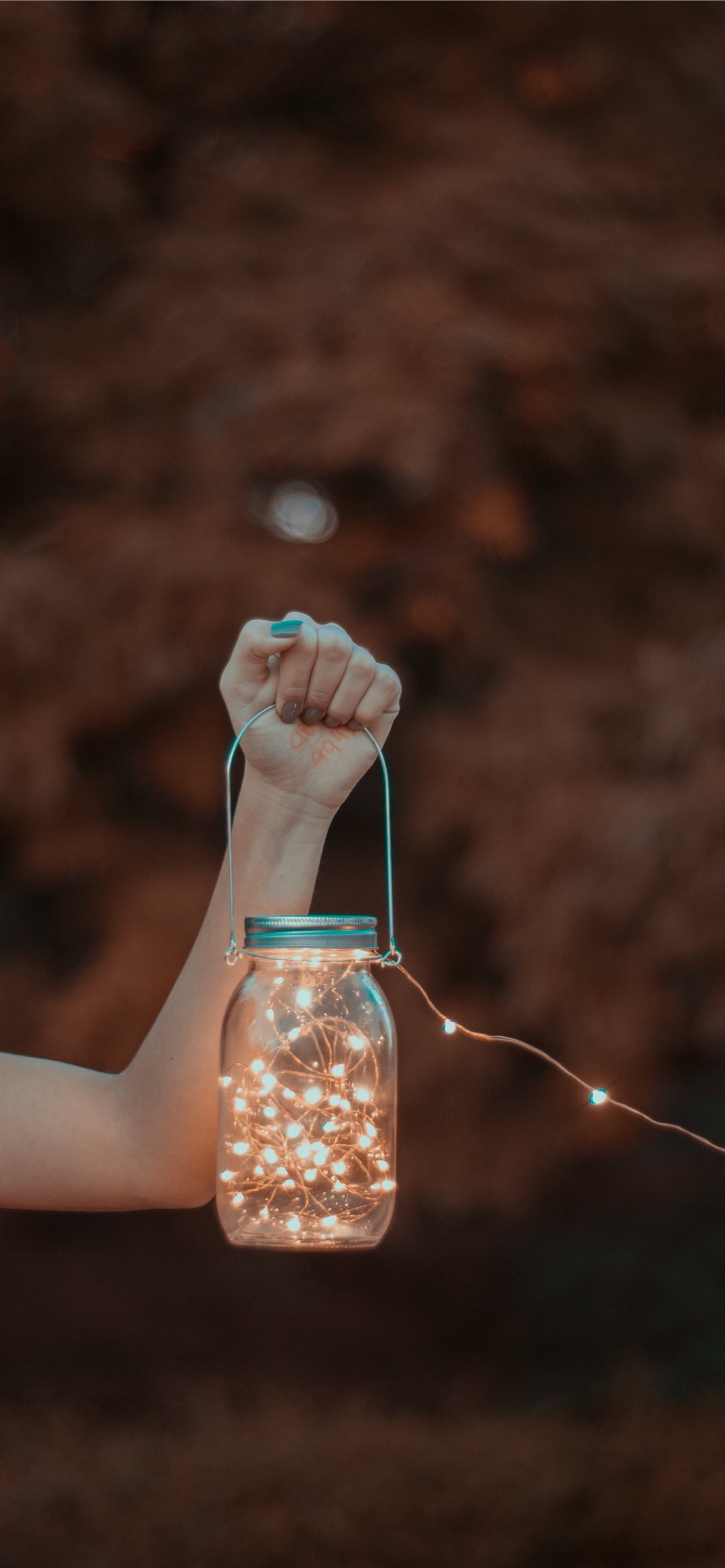 Person Holding Mason Jar With String Lights Iphone Wallpapers Free Download