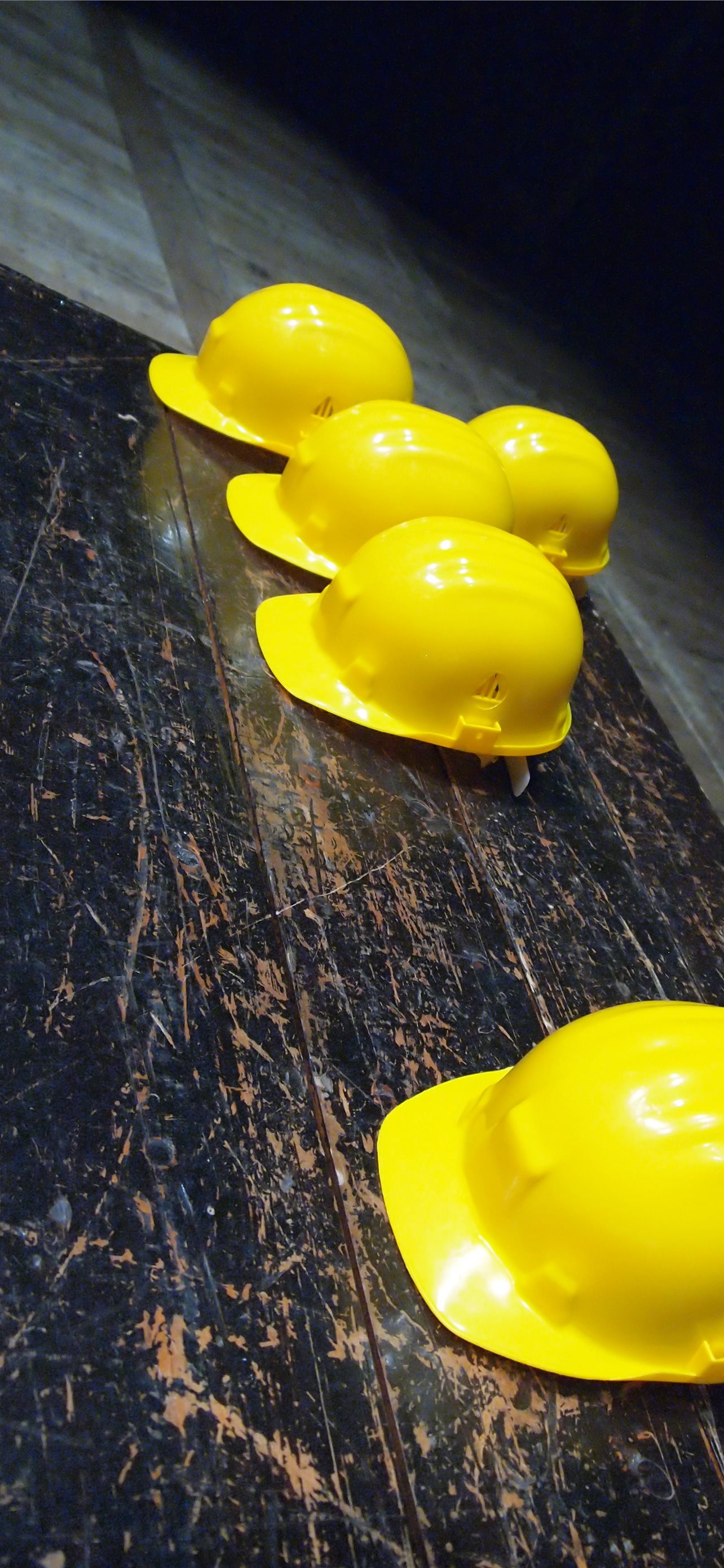 five yellow hard hats on gray surface iPhone wallpaper 