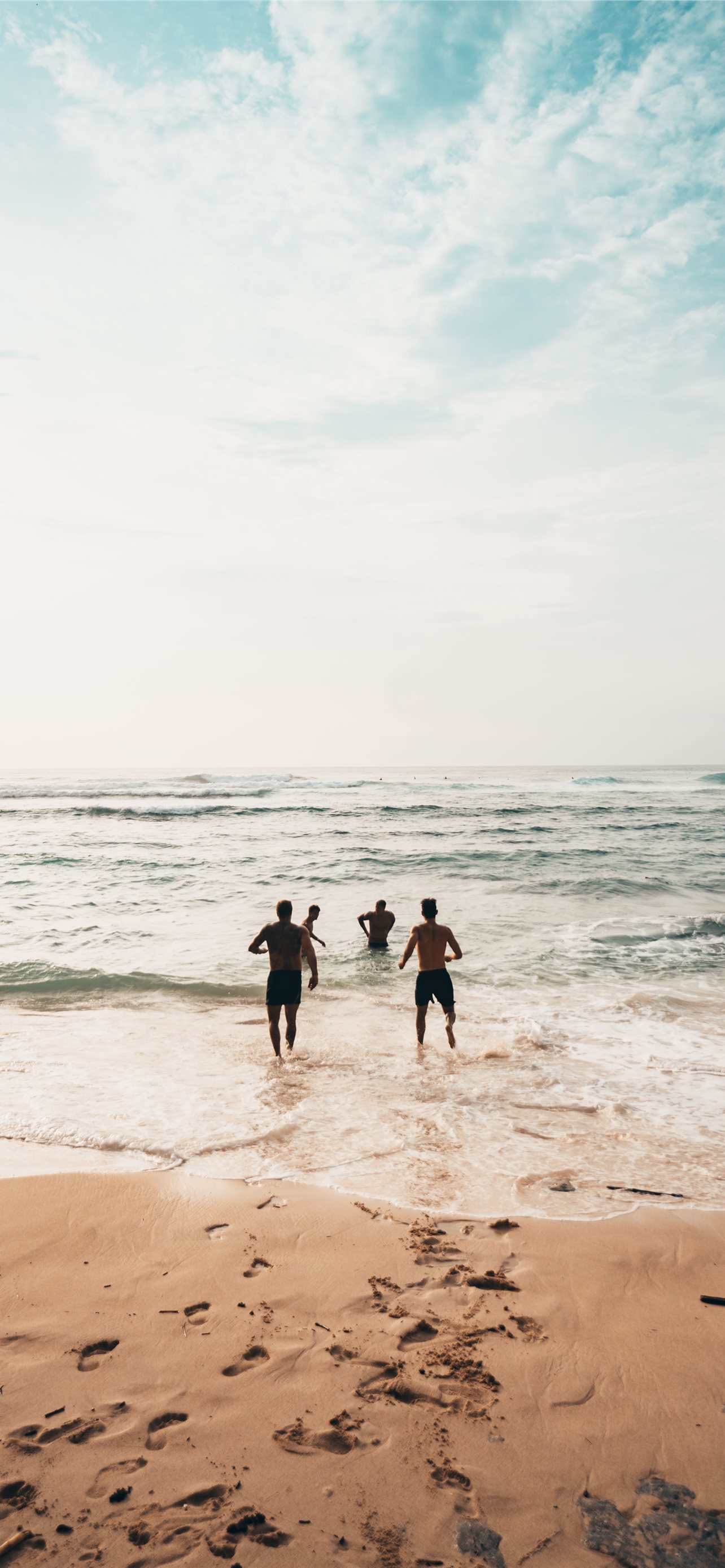 men running toward beach iPhone wallpaper 