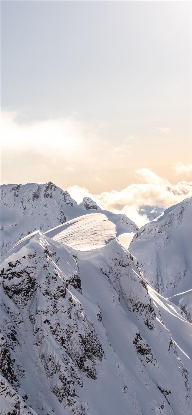mountains covered by snow at daytime iPhone 12 wallpaper 