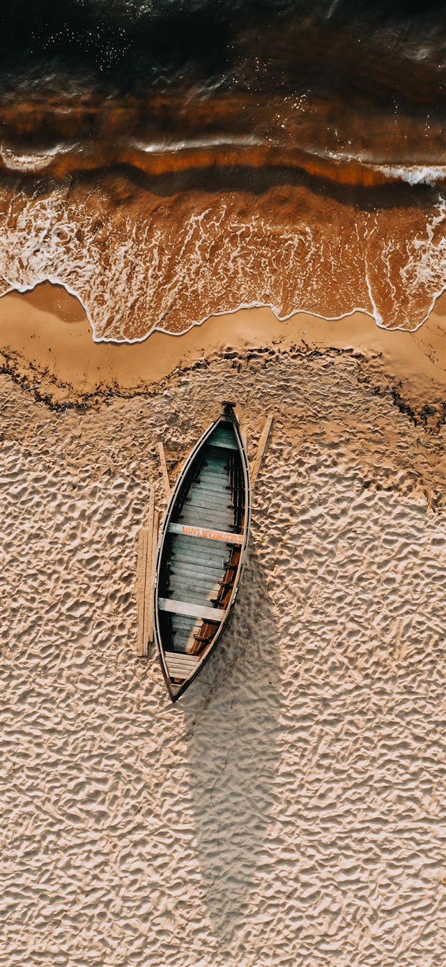 brown and white boat on brown sand iPhone 12 wallpaper 