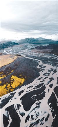 aerial view of black and white mountains under clo... wallpaper