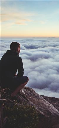 person looking at the clouds from top wallpaper