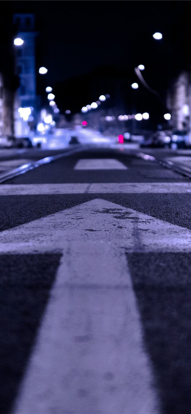 shallow focus photography of road with forward arr... iPhone 12 wallpaper 