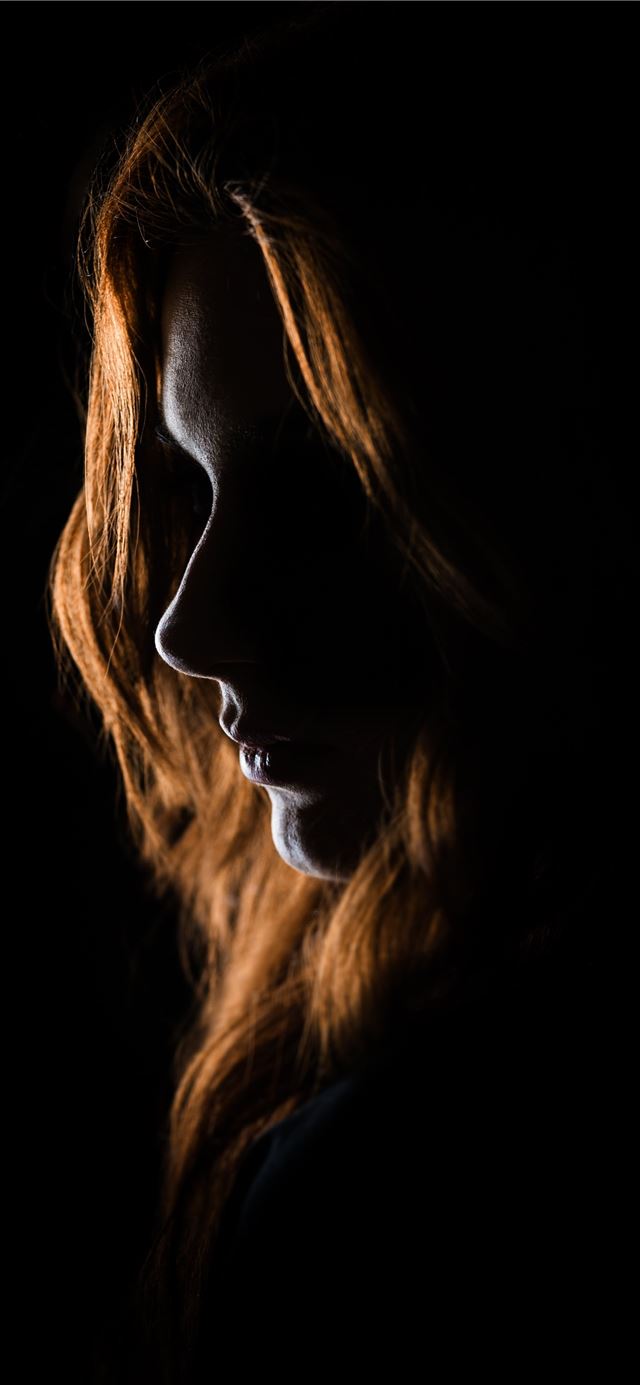 woman's face on black background iPhone 12 wallpaper 