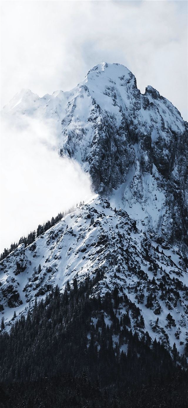 snowy mountain covered with clouds iPhone 12 wallpaper 