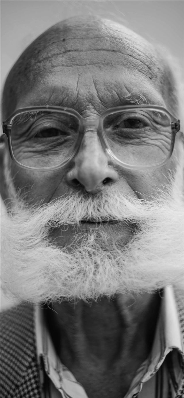 grayscale photo of man wearing eyeglasses iPhone 12 wallpaper 
