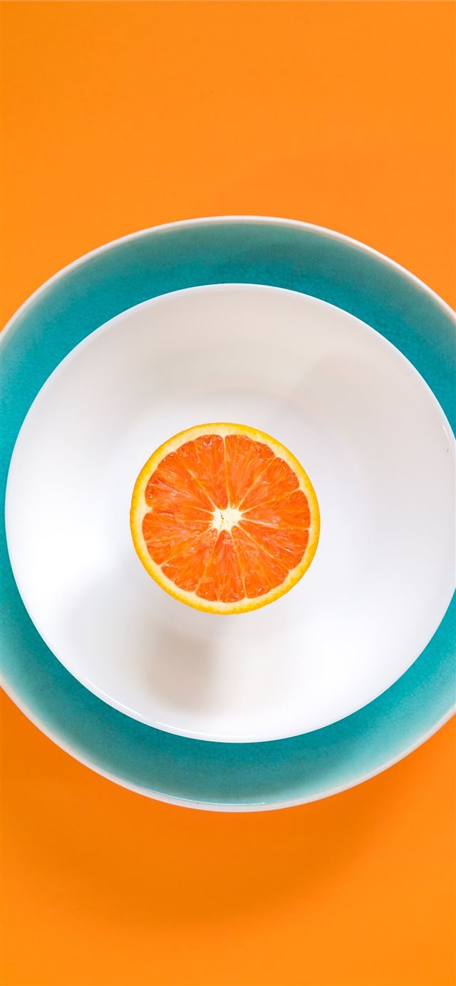 sliced orange fruit in bowl iPhone 12 wallpaper 