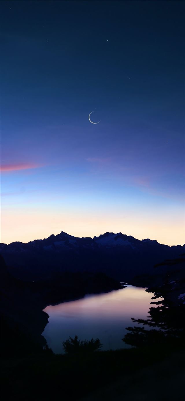 birds eye view of lake under crescent moon iPhone 12 wallpaper 