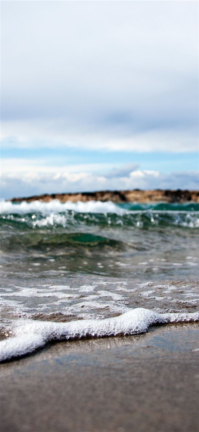 waves under white cloudy sky at daytime iPhone 12 wallpaper 