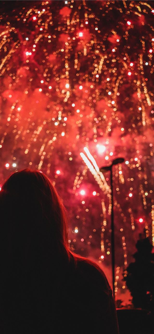 person looking at fireworks iPhone 12 wallpaper 