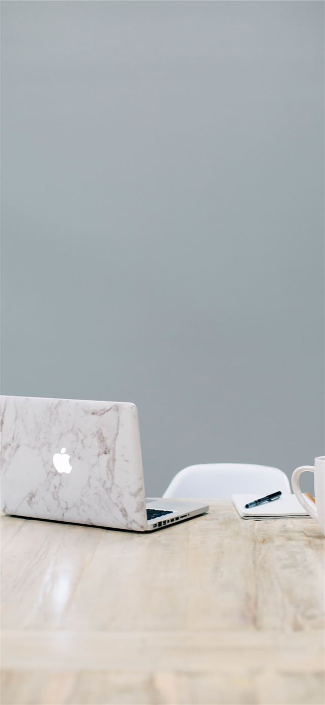 MacBook on table near mug iPhone 12 wallpaper 