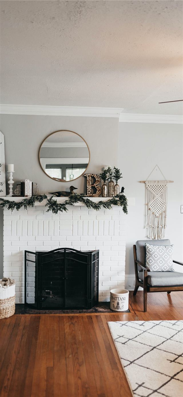 white fireplace mantel with decors iPhone 12 wallpaper 