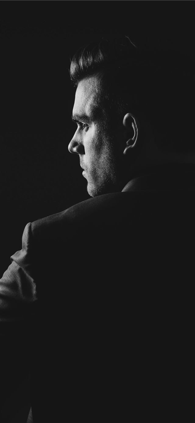 grayscale photo of man wearing blazer iPhone 12 wallpaper 