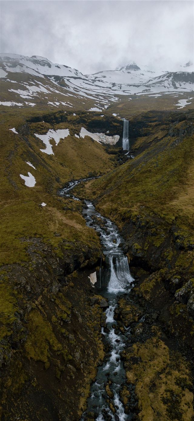 waterfall and river between hills iPhone 12 wallpaper 