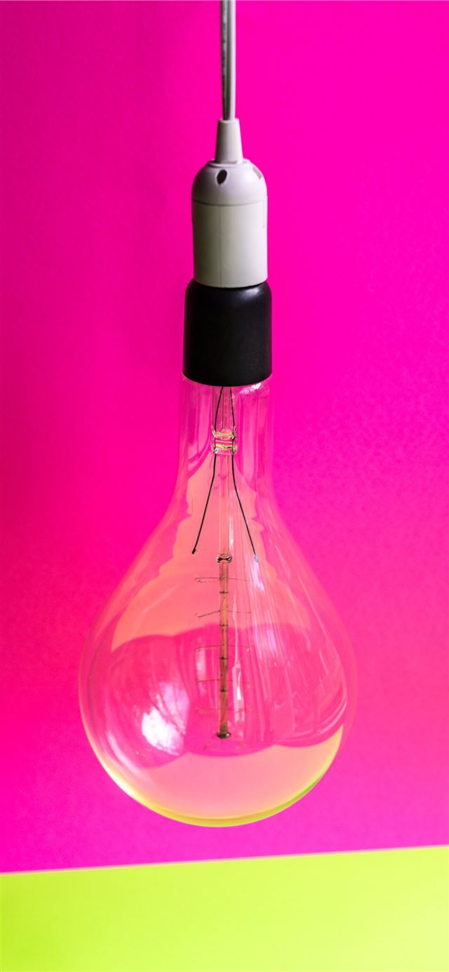 close up photo of light bulb with pink background iPhone 12 wallpaper 