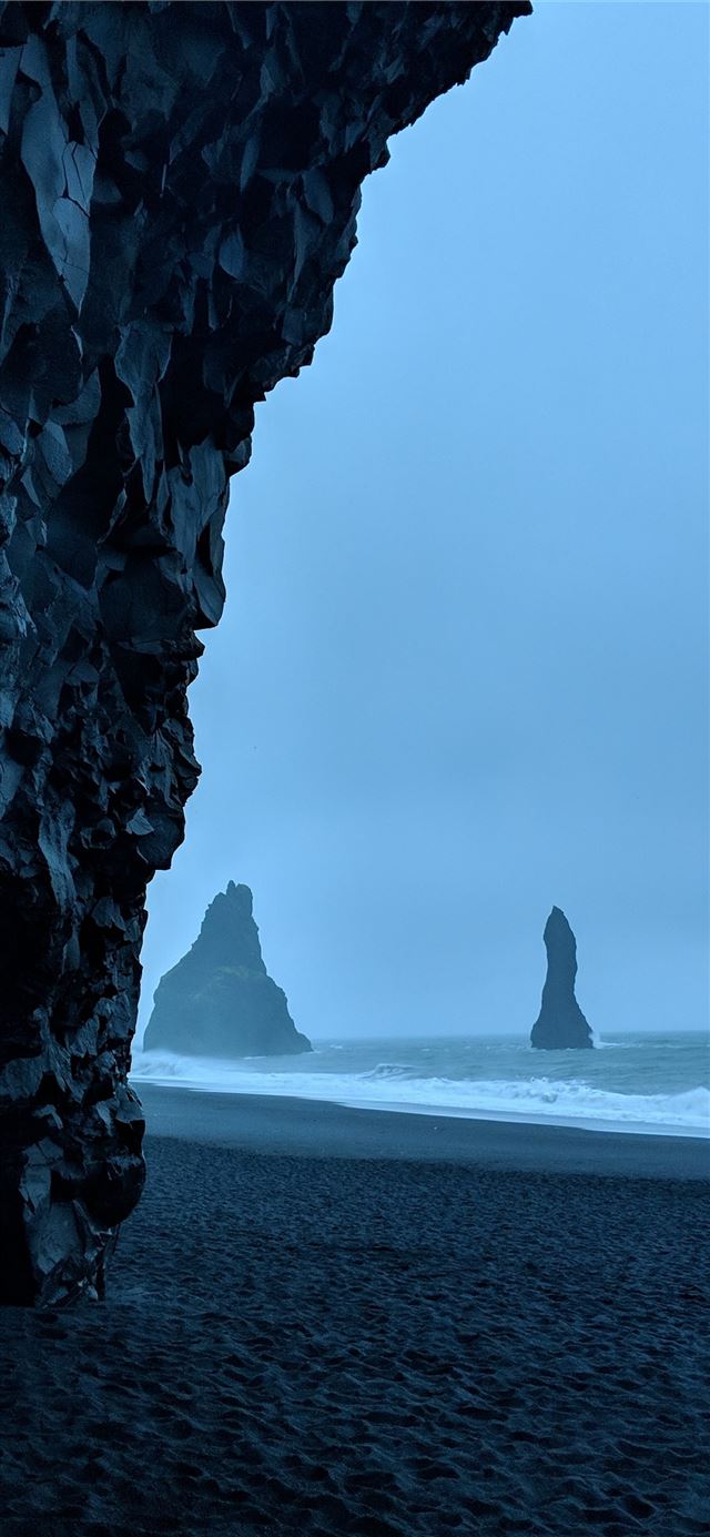 black rock formations in beach iPhone 12 wallpaper 