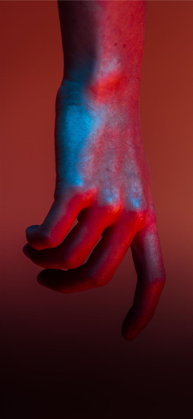 shallow focus photography of hand with red paint iPhone 12 wallpaper 