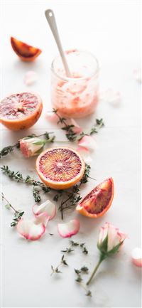 sliced blood orange fruits with white and pink pet... wallpaper