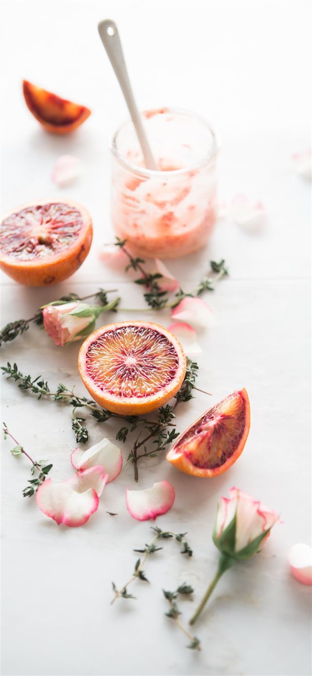 sliced blood orange fruits with white and pink pet... iPhone 12 wallpaper 