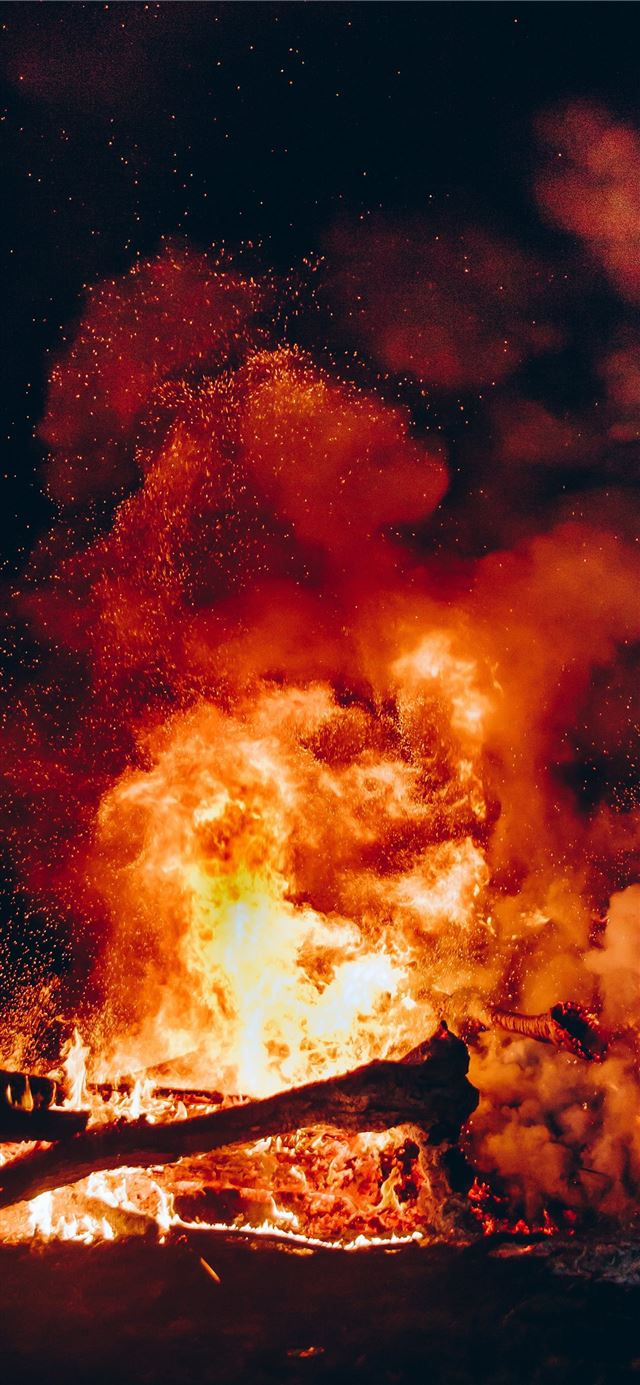 fire with black smoke during night iPhone 12 wallpaper 
