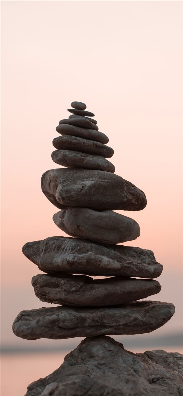 closeup photography of cairn stone iPhone 12 wallpaper 