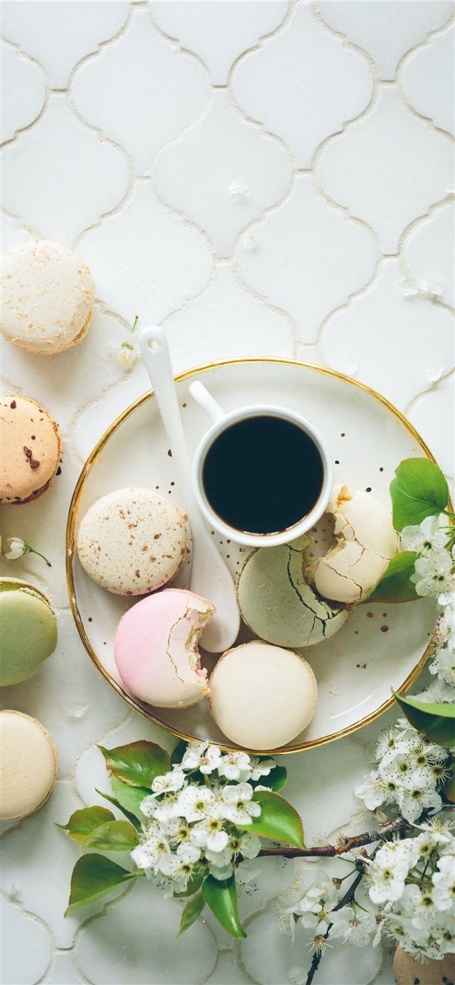 macarons beside teacup and ladle on round white ce... iPhone 12 wallpaper 