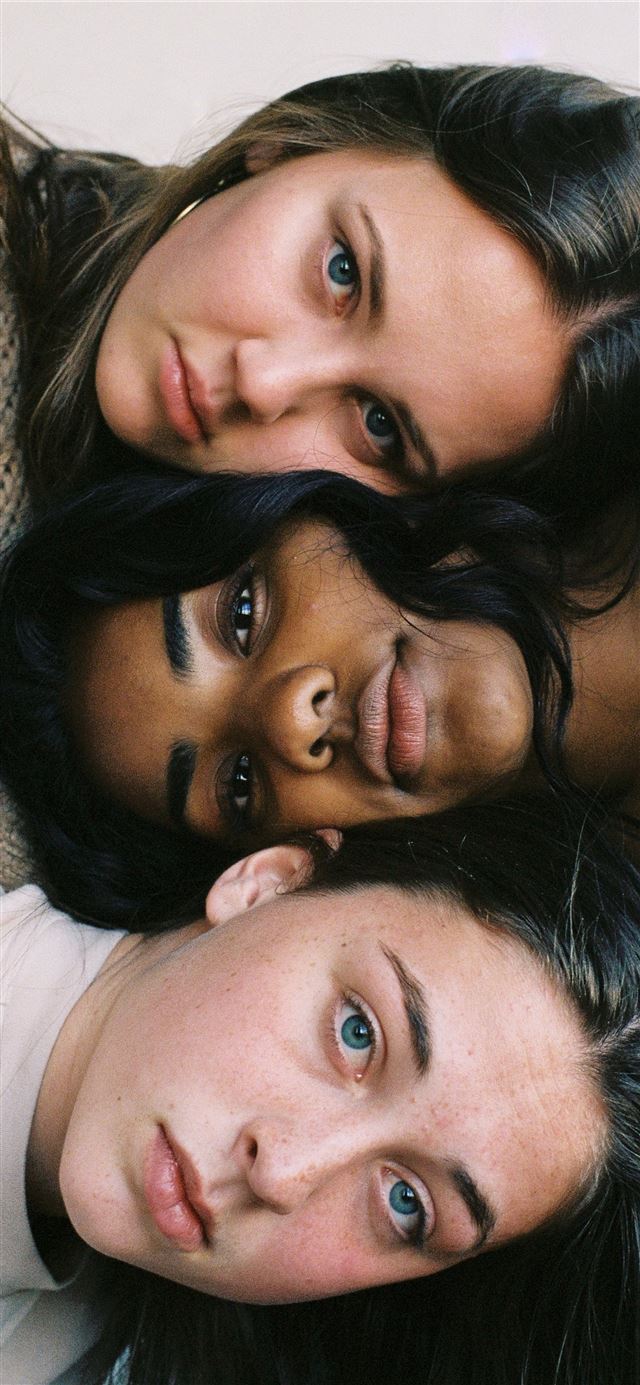 three women in assorted color tops iPhone 12 wallpaper 