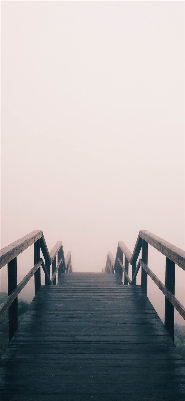 black wooden stairway covered with fog iPhone 12 wallpaper 