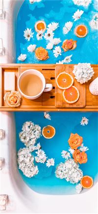 filled mug on brown wooden bathtub tray wallpaper