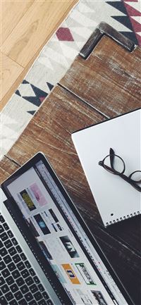 turned on MacBook Pro near black framed eyeglasses wallpaper